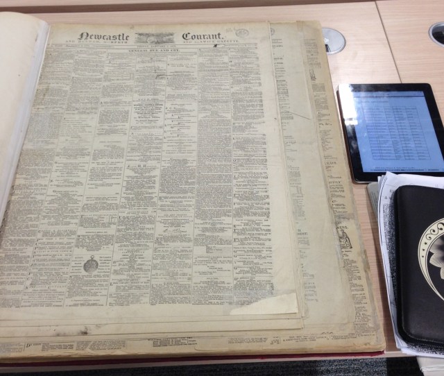 Newspaper versus ipad for size comparison.